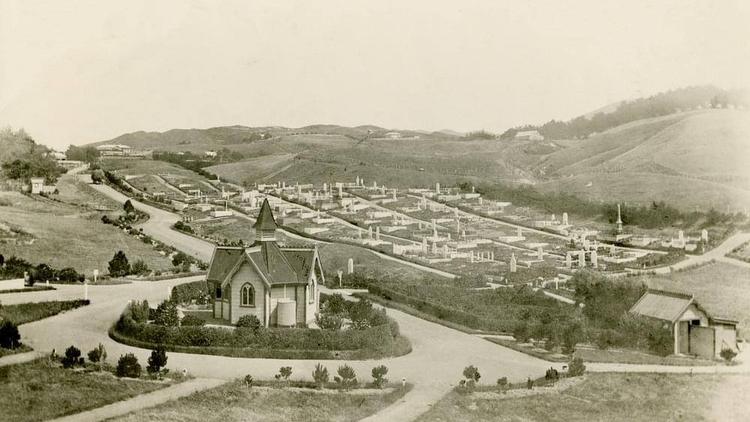 Historic sepia photograph of Karori Cemetery, with a chapel in the foreground