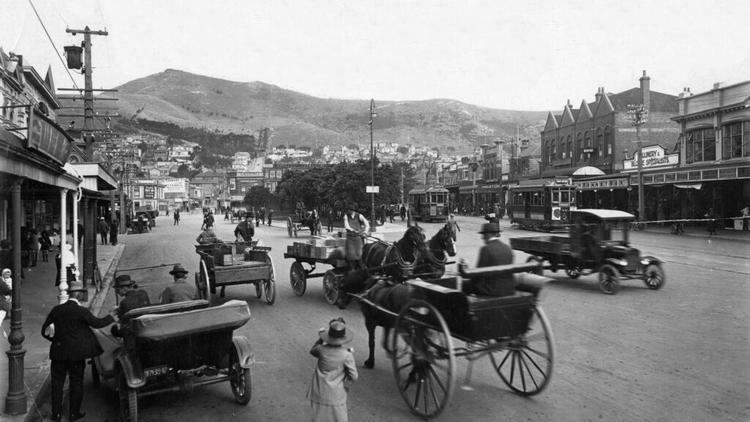 1920s photo of vintage cars and carts with horses along Courtney Place