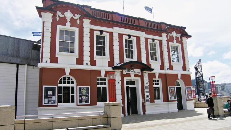 Exterior of red and white Circa theatre building